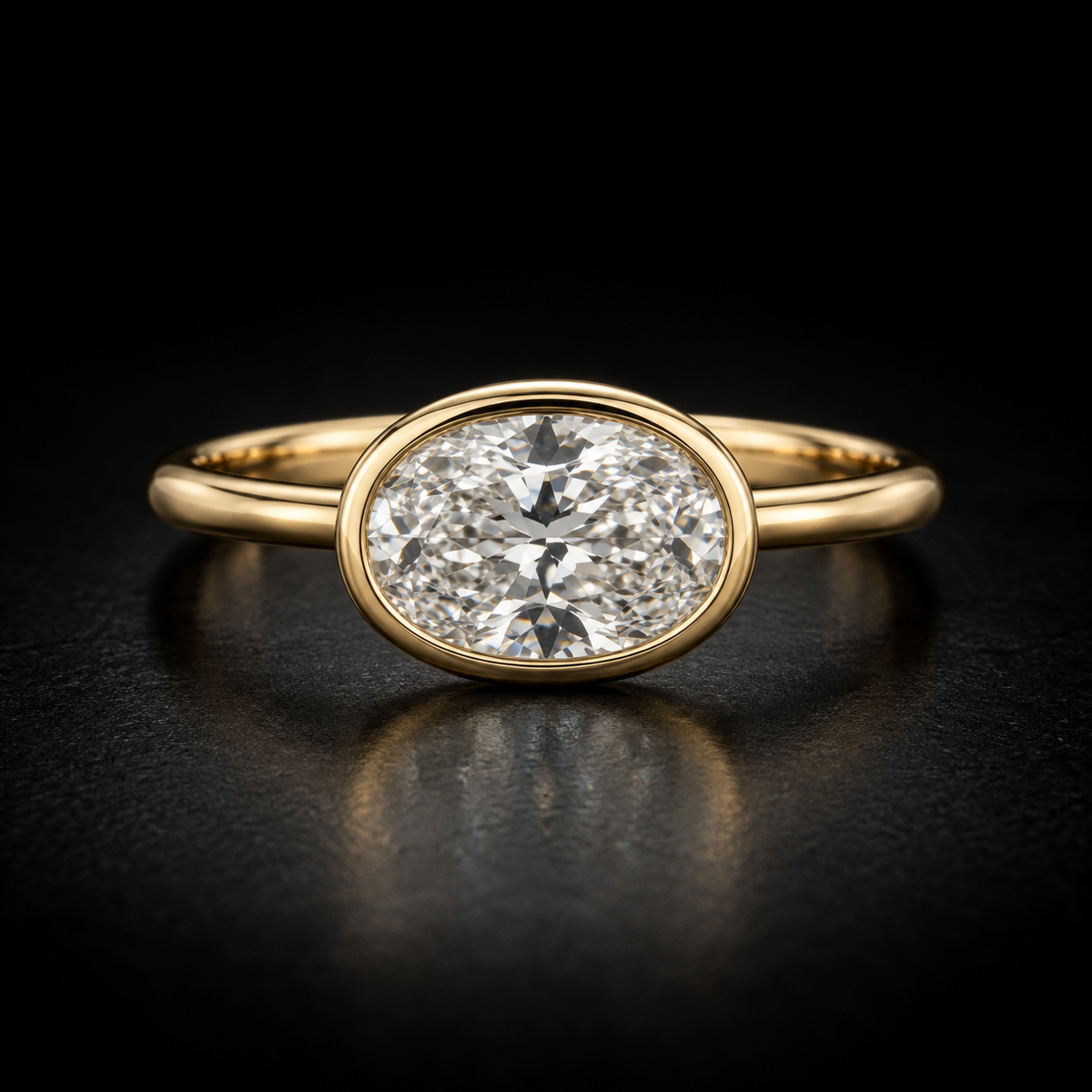 East-West Oval Bezel-Set Solitaire Engagement Ring in 18kt yellow gold