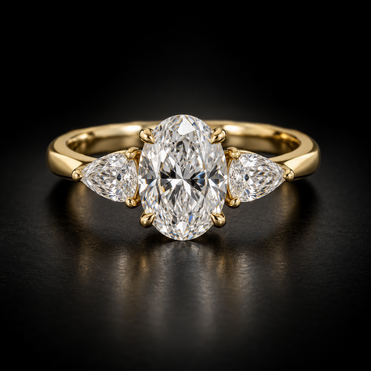 Oval and Pear Three-Stone Engagement Ring in 18kt yellow gold