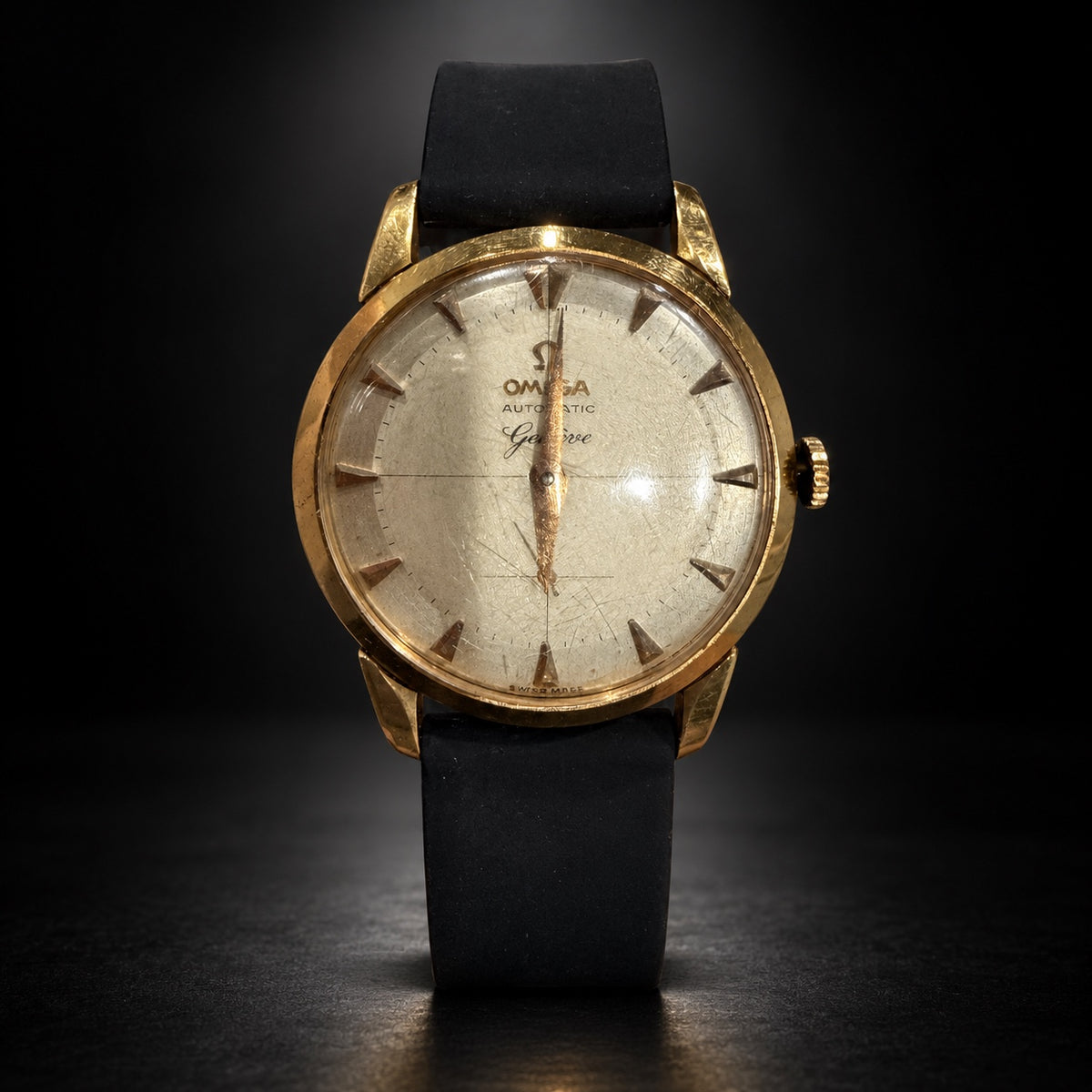 Front view of vintage Omega Genève automatic gold-tone dress watch with champagne dial and black strap